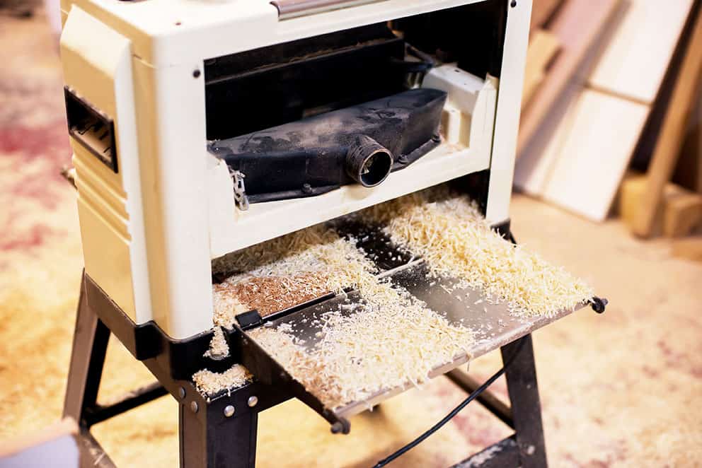 Benchtop planer covered in sawdust